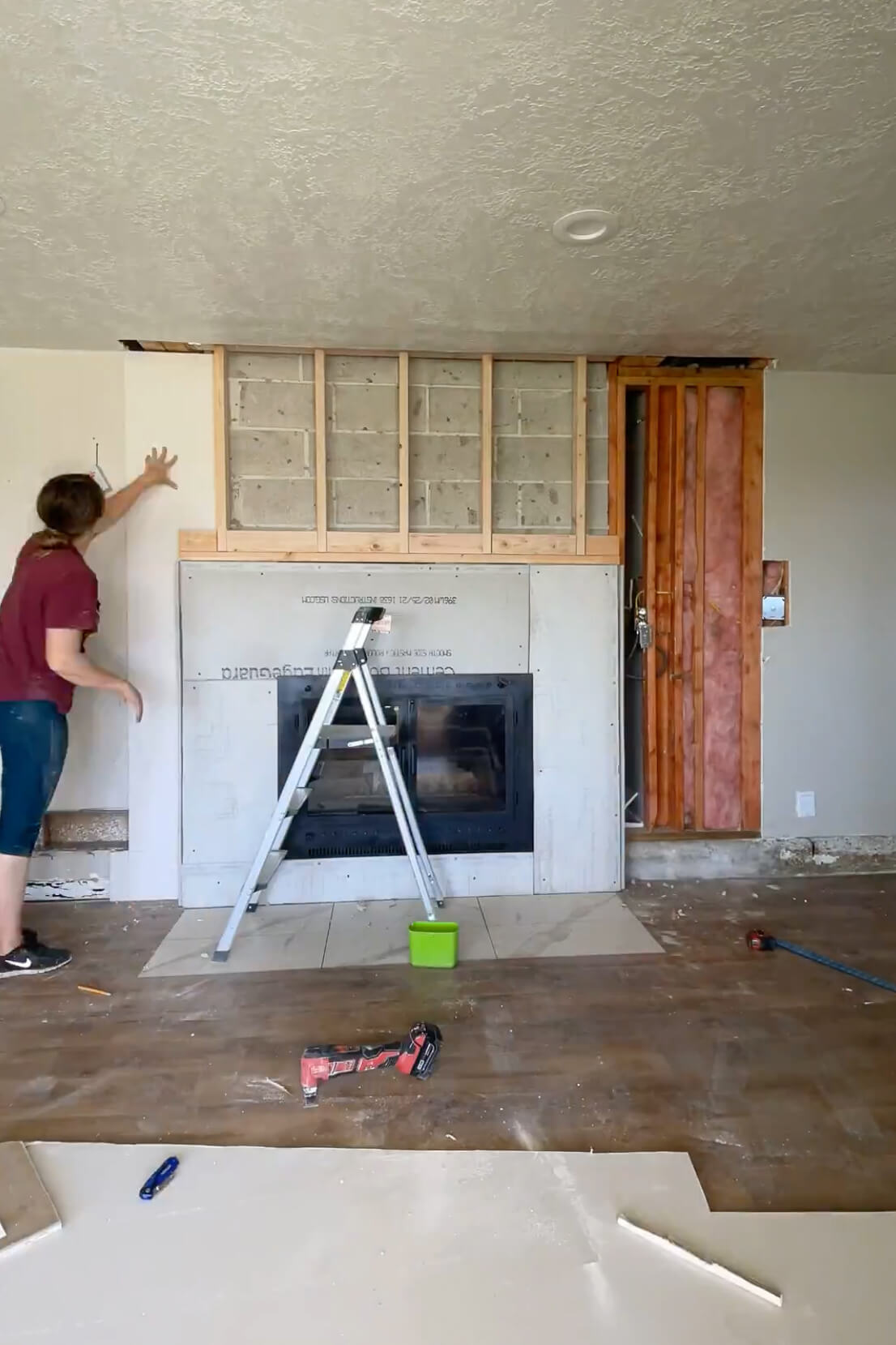 Drywalling around a fireplace.